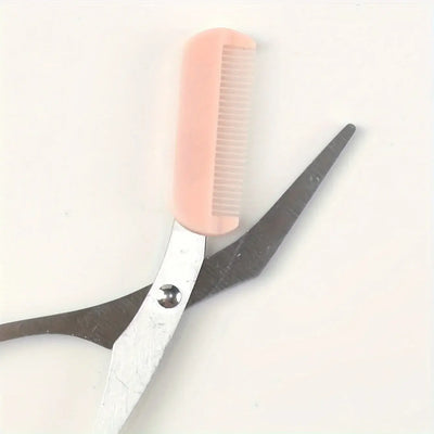 Frost Glow Cosmetics pink eyebrow scissors with built-in comb. Stainless steel, precise grooming tool for shaping perfect brows.