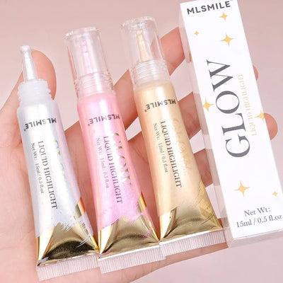 Model showcasing Frost Glow liquid highlighter with radiant skin and glossy makeup look.