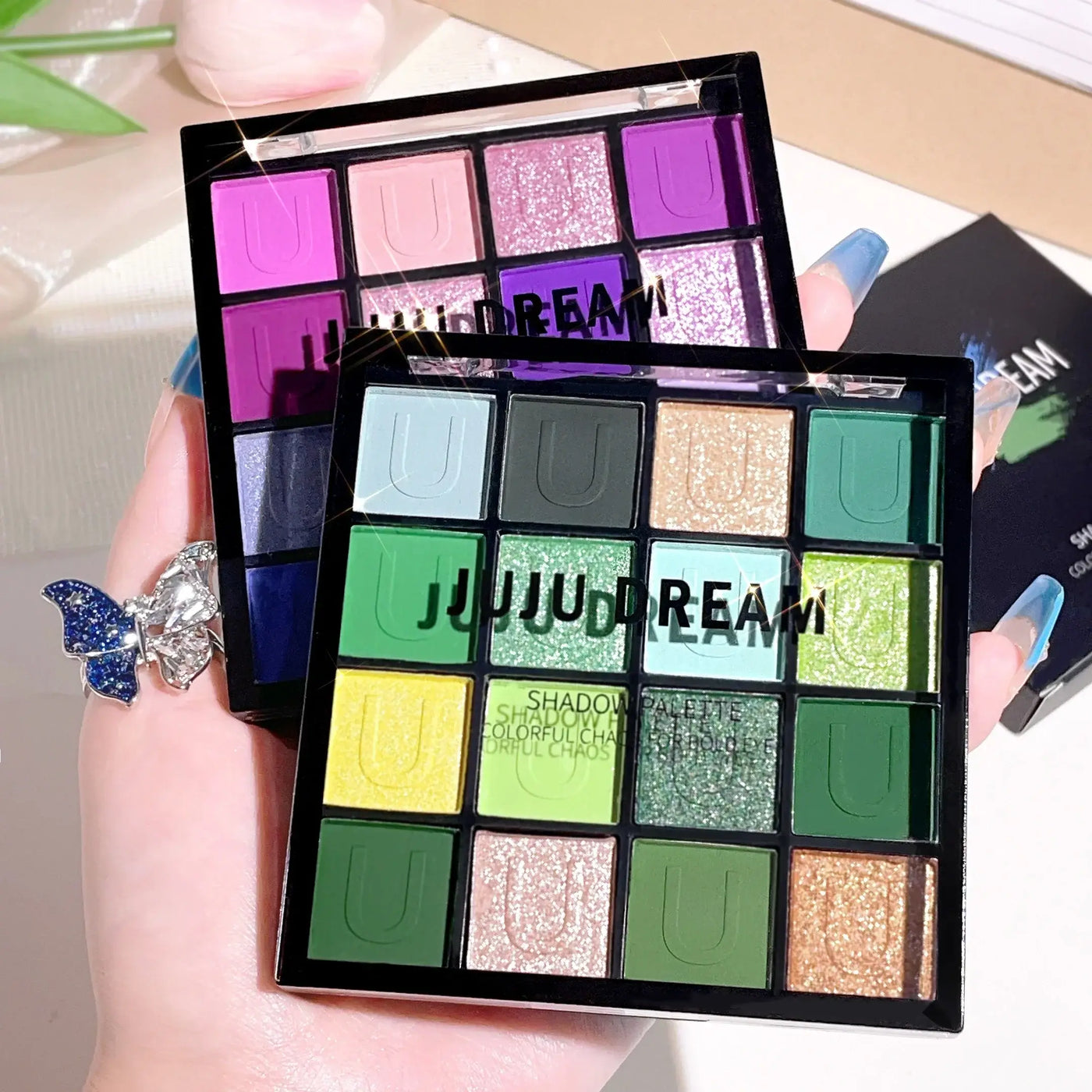Frost Glow Cosmetics 16-color eyeshadow palette. Matte, pearl & glitter shades like Koi, Mermaid & Enchanted Forest for festival looks.