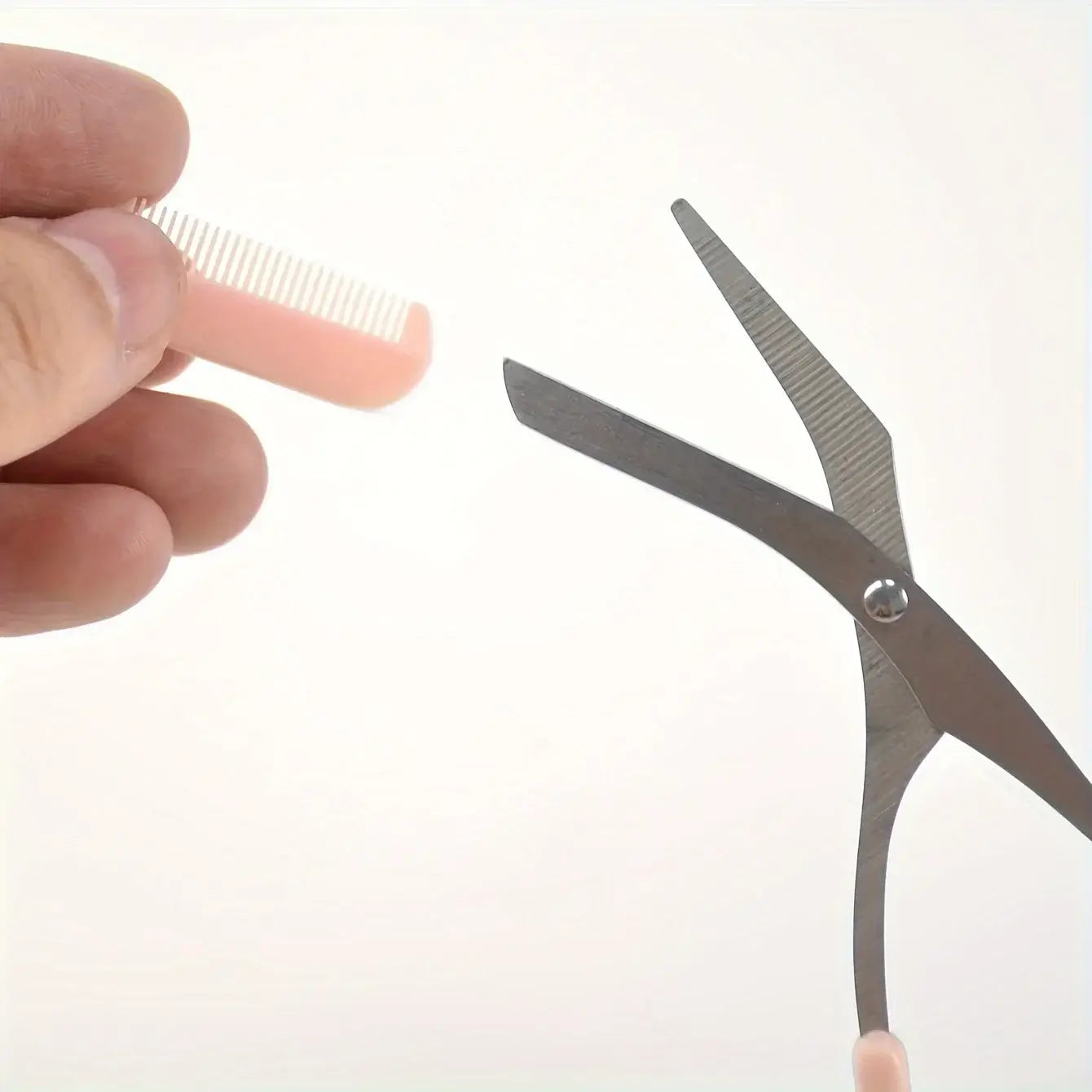 Frost Glow Cosmetics pink eyebrow scissors with built-in comb. Stainless steel, precise grooming tool for shaping perfect brows.