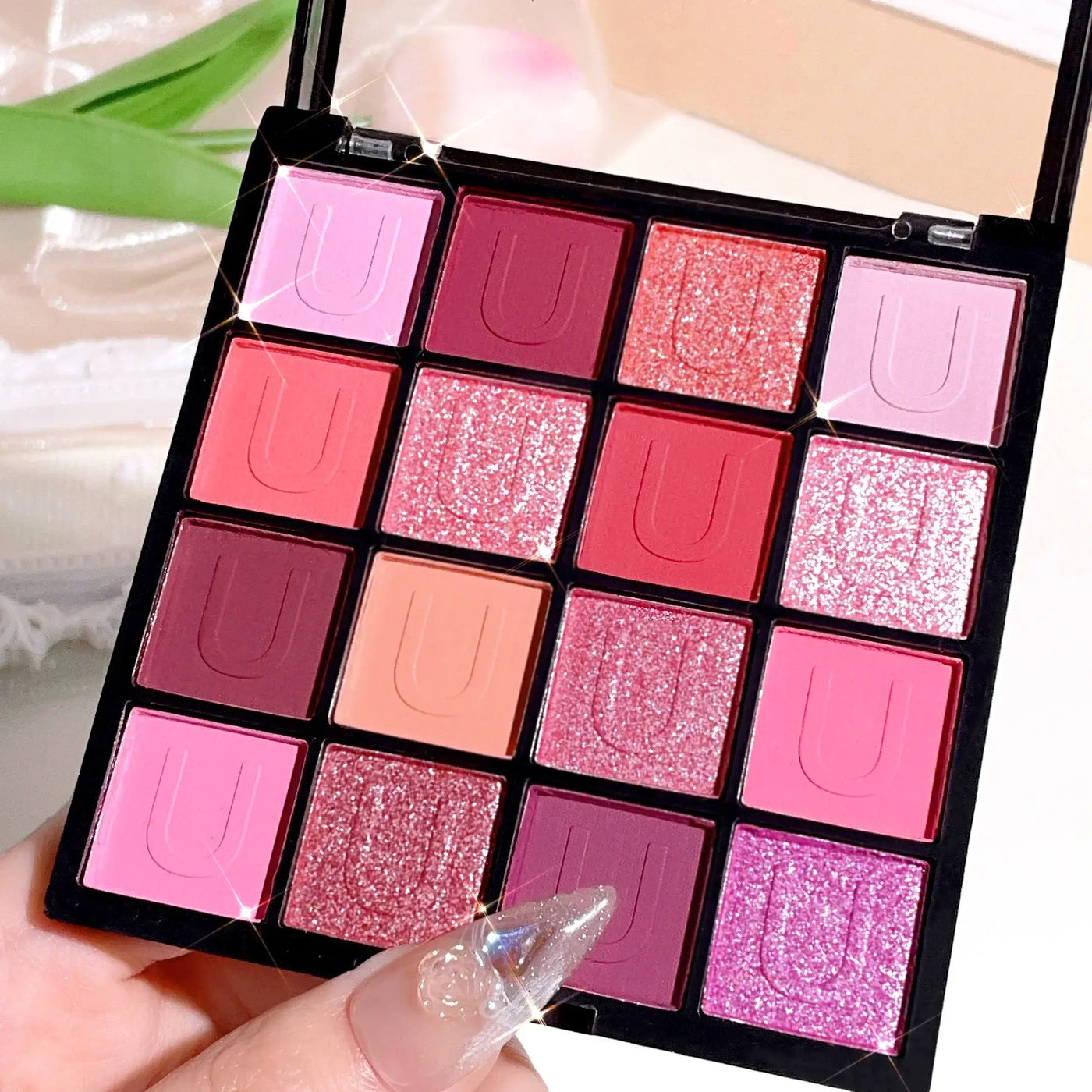 Frost Glow Cosmetics 16-color eyeshadow palette. Matte, pearl & glitter shades like Koi, Mermaid & Enchanted Forest for festival looks.