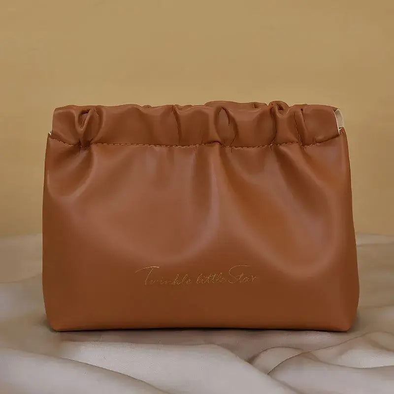 Stylish PU makeup bag with self-closing design. Perfect for travel, cosmetics, and daily essentials. Shop Frost Glow Cosmetics beauty storage today!