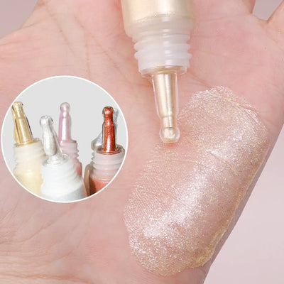 Model showcasing Frost Glow liquid highlighter with radiant skin and glossy makeup look.