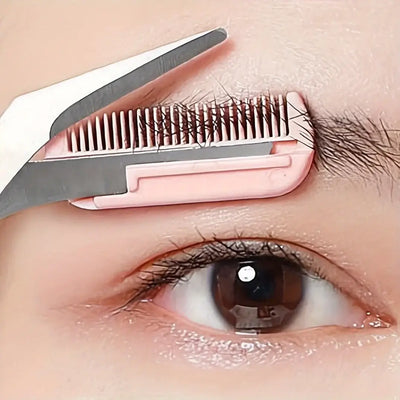 Frost Glow Cosmetics pink eyebrow scissors with built-in comb. Stainless steel, precise grooming tool for shaping perfect brows.