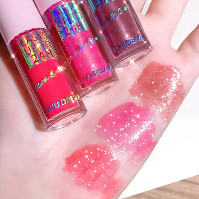 Frost Glow Cosmetics lip gloss with glitter glaze on sparkling pink lips, showcasing long-lasting shimmer in a stylish design.