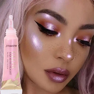 Model showcasing Frost Glow liquid highlighter with radiant skin and glossy makeup look.