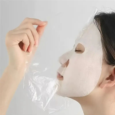 Frost Glow Cosmetics 100pcs facial mask paper sheets are unscented, hydrating & moisture-retentive DIY skincare wraps for soft skin.
