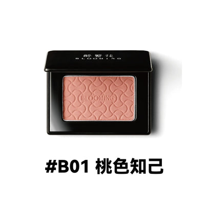 Model showcasing Blooming Blush Powder in B07, featuring soft pink tones and long-lasting cheek tint effect.