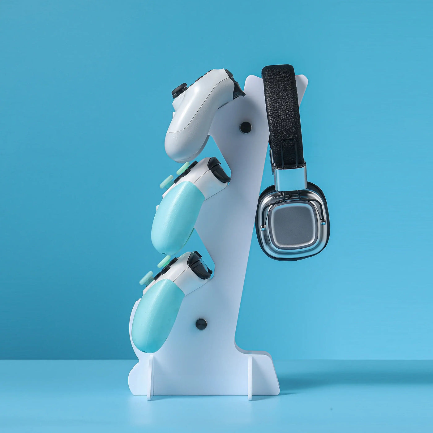 Frost Glow Cosmetics universal 3-layer stand for PS5, PS4, Xbox, and Switch controllers with headphone holder. Durable & space-saving.