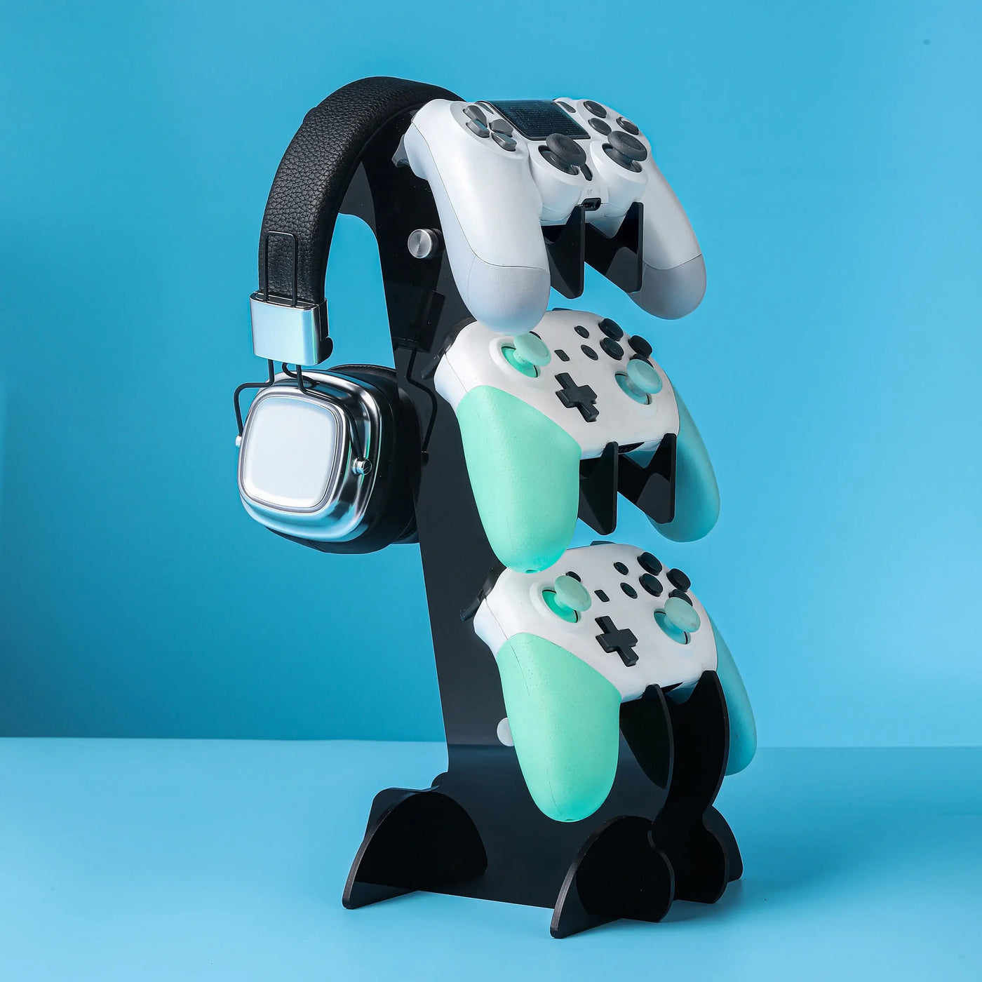 Frost Glow Cosmetics universal 3-layer stand for PS5, PS4, Xbox, and Switch controllers with headphone holder. Durable & space-saving.