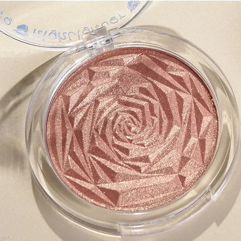 Frost Glow Cosmetics Diamond Glow highlighter showcased on skin and model, featuring shimmering rose-patterned design.