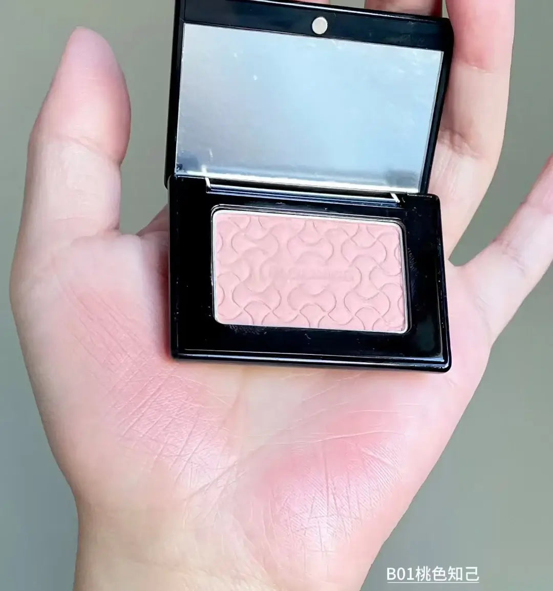 Model showcasing Blooming Blush Powder in B07, featuring soft pink tones and long-lasting cheek tint effect.