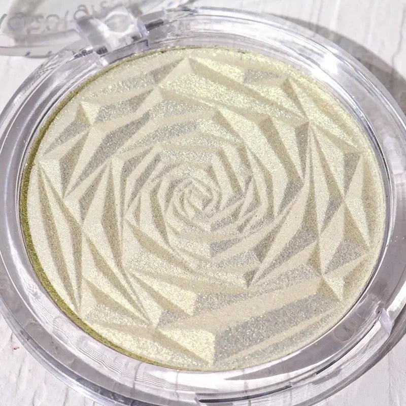 Frost Glow Cosmetics Diamond Glow highlighter showcased on skin and model, featuring shimmering rose-patterned design.
