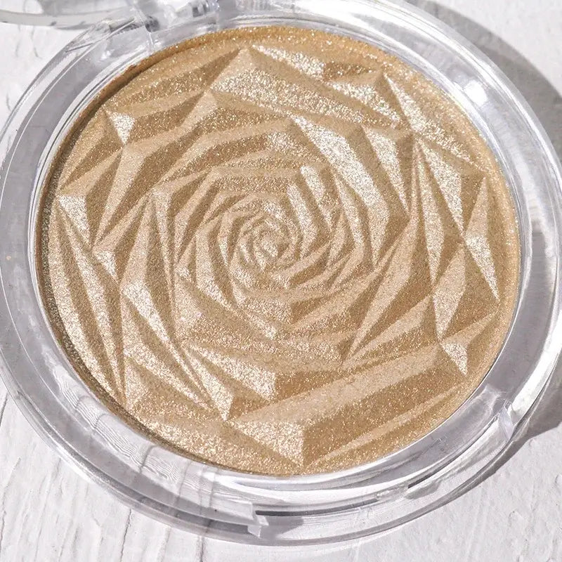 Frost Glow Cosmetics Diamond Glow highlighter showcased on skin and model, featuring shimmering rose-patterned design.