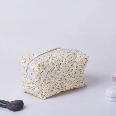 Spacious floral quilted makeup bag with soft puffy design. Perfect for travel or daily use to keep cosmetics organized. Shop Frost Glow Cosmetics today!