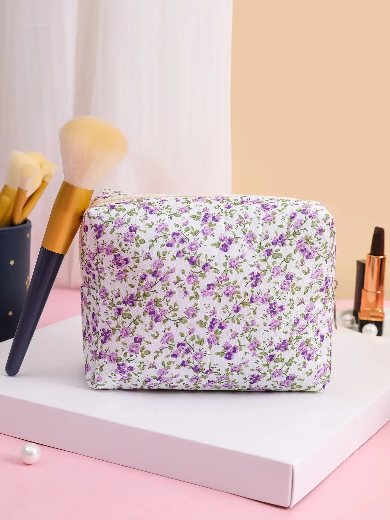 Spacious floral quilted makeup bag for travel & daily use. Puffy, stylish & durable design keeps cosmetics organized. Shop Frost Glow Cosmetics today!