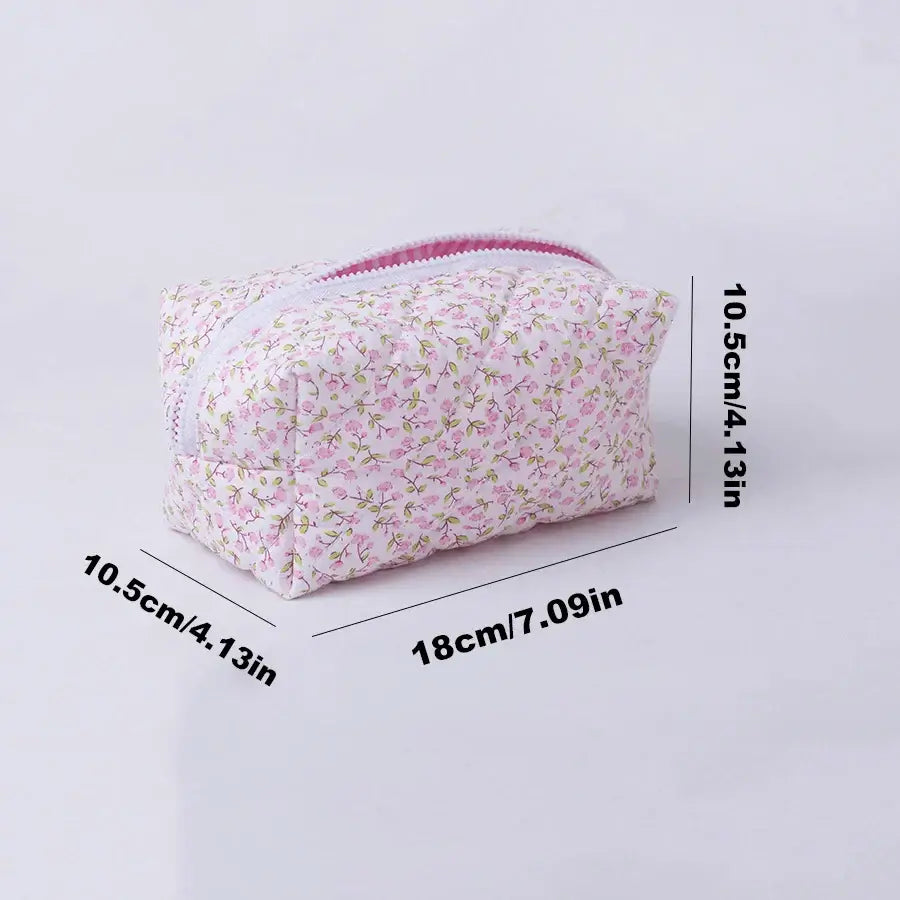 Spacious floral quilted makeup bag with soft puffy design. Perfect for travel or daily use to keep cosmetics organized. Shop Frost Glow Cosmetics today!