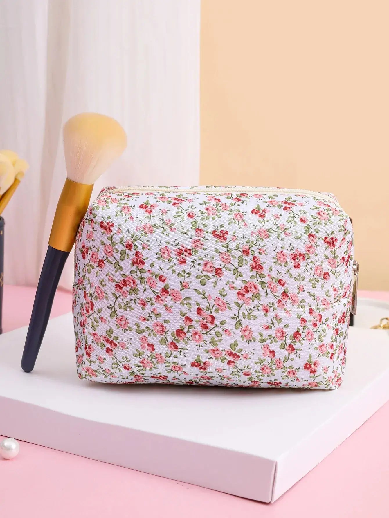 Spacious floral quilted makeup bag for travel & daily use. Puffy, stylish & durable design keeps cosmetics organized. Shop Frost Glow Cosmetics today!