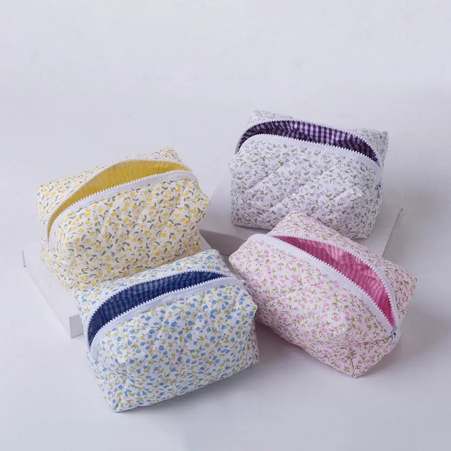 Spacious floral quilted makeup bag with soft puffy design. Perfect for travel or daily use to keep cosmetics organized. Shop Frost Glow Cosmetics today!