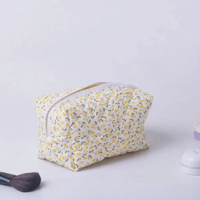 Spacious floral quilted makeup bag with soft puffy design. Perfect for travel or daily use to keep cosmetics organized. Shop Frost Glow Cosmetics today!