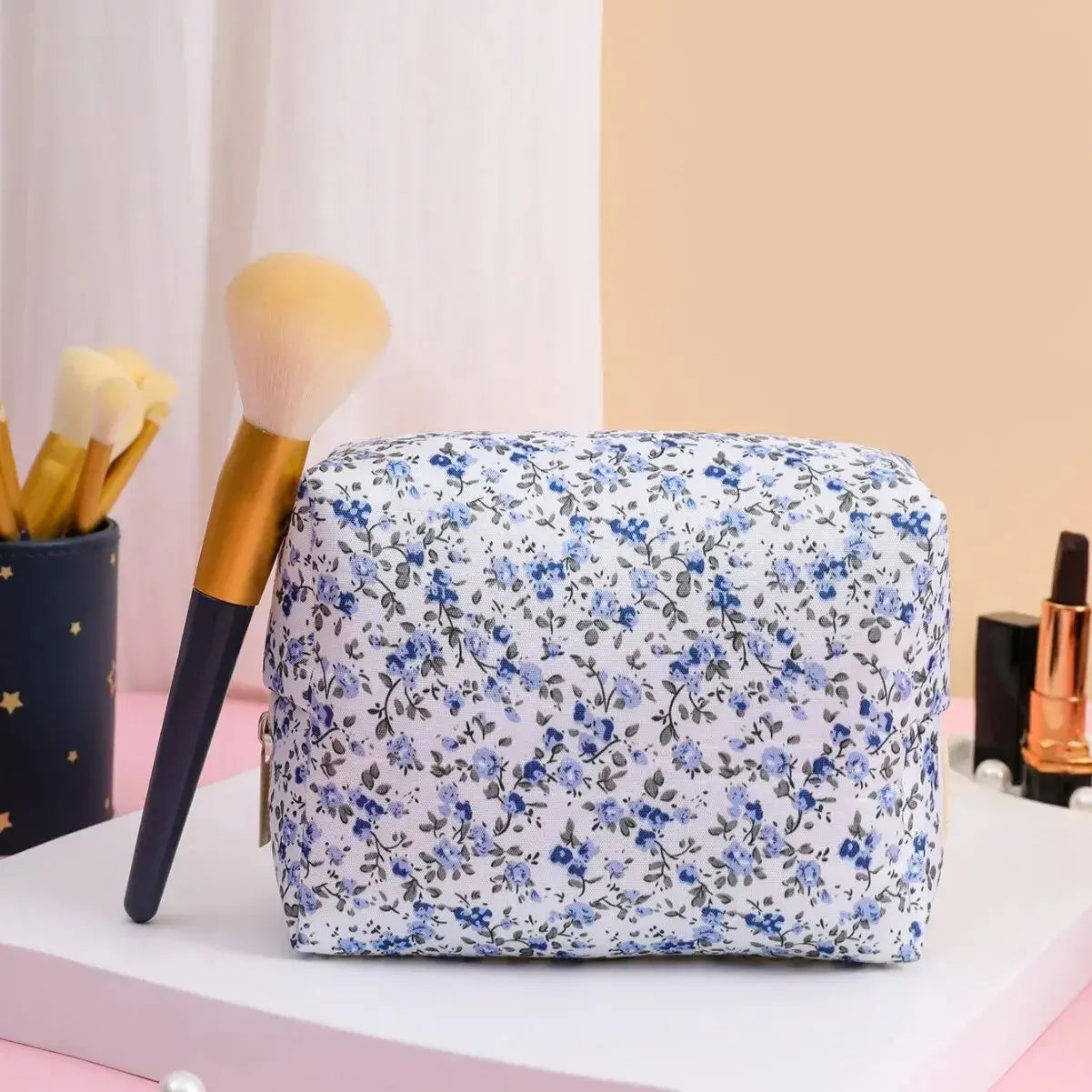 Spacious floral quilted makeup bag for travel & daily use. Puffy, stylish & durable design keeps cosmetics organized. Shop Frost Glow Cosmetics today!