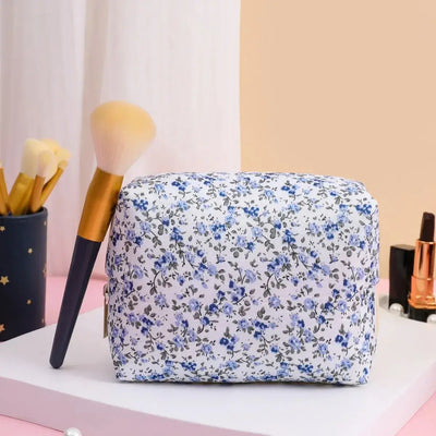 Spacious floral quilted makeup bag for travel & daily use. Puffy, stylish & durable design keeps cosmetics organized. Shop Frost Glow Cosmetics today!