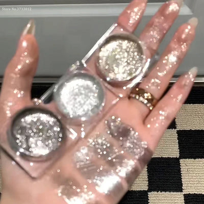 Close-up of shimmery gel eyeshadow in silver shades, with a model featuring sparkling eye makeup.