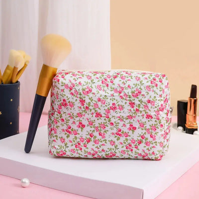 Spacious floral quilted makeup bag for travel & daily use. Puffy, stylish & durable design keeps cosmetics organized. Shop Frost Glow Cosmetics today!