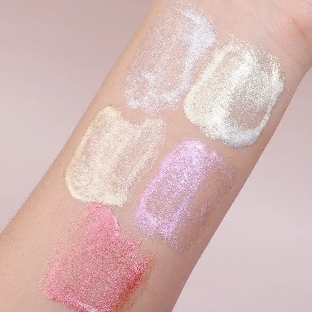 Model showcasing Frost Glow liquid highlighter with radiant skin and glossy makeup look.