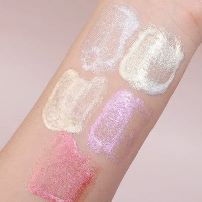 Model showcasing Frost Glow liquid highlighter with radiant skin and glossy makeup look.