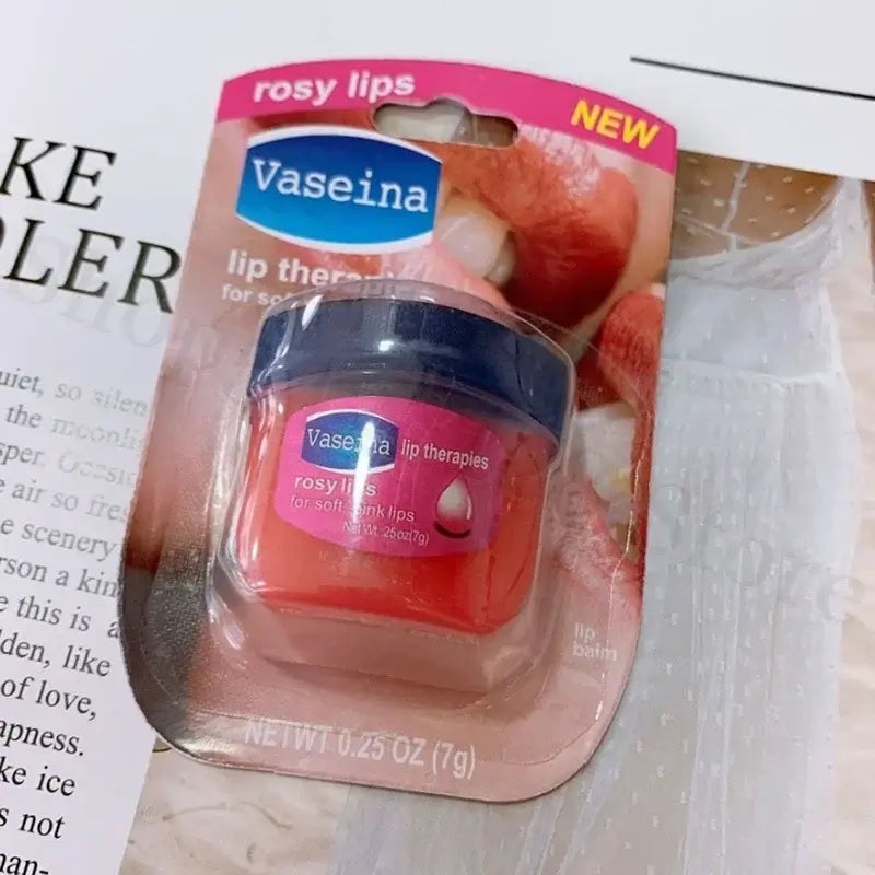 Four Vaseline lip balm jars in packaging, featuring rosy lips, caramel pudding, cocoa butter, and original flavors.