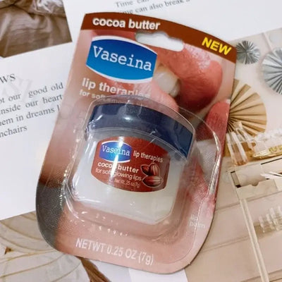 Four Vaseline lip balm jars in packaging, featuring rosy lips, caramel pudding, cocoa butter, and original flavors.