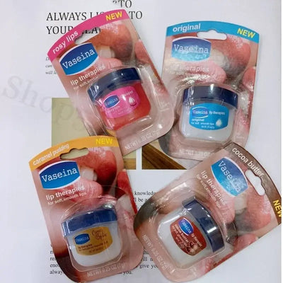 Four Vaseline lip balm jars in packaging, featuring rosy lips, caramel pudding, cocoa butter, and original flavors.